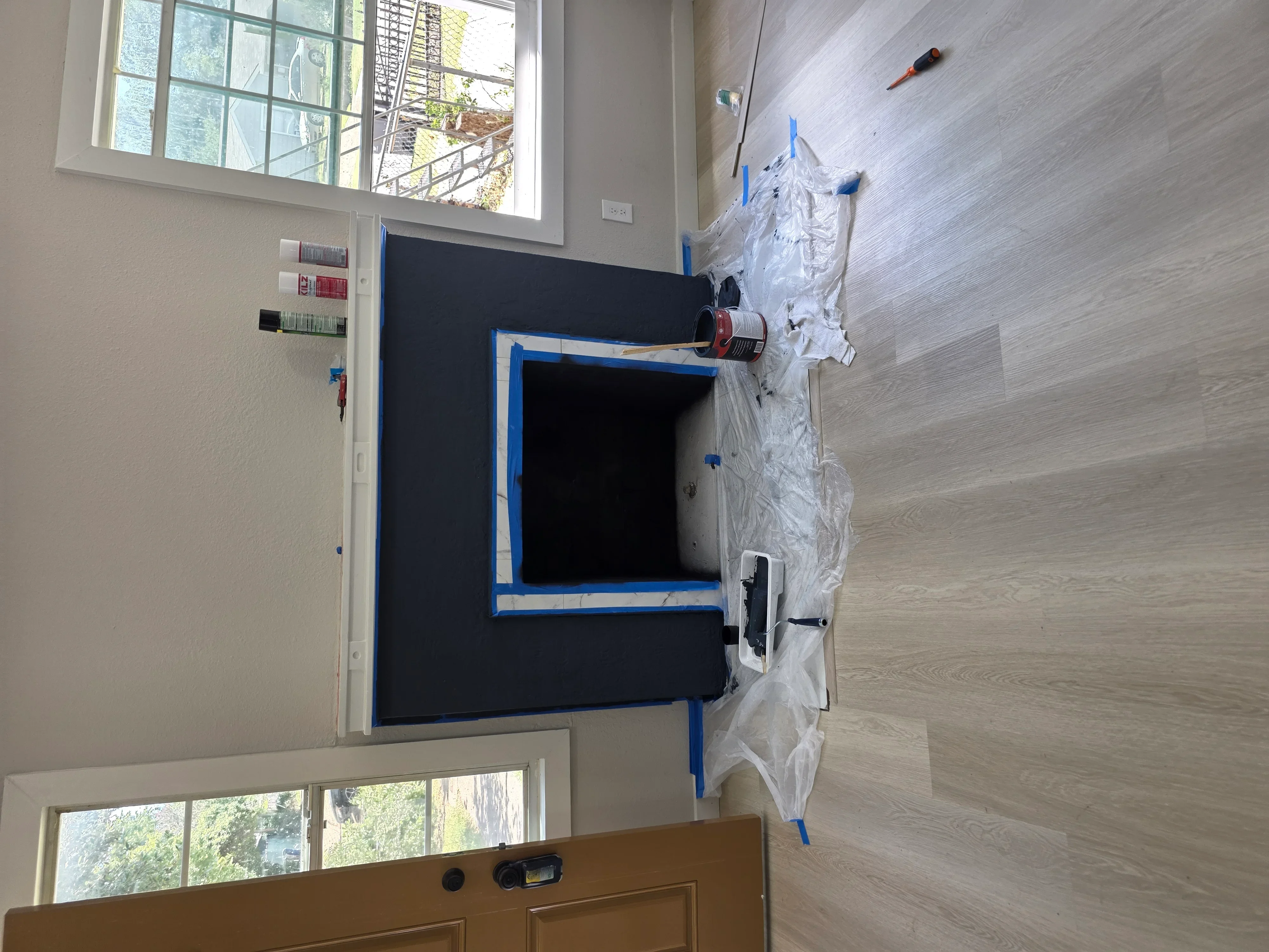 Electrical outlet installation with junction box, conduit, and protective sheeting during residential wiring project