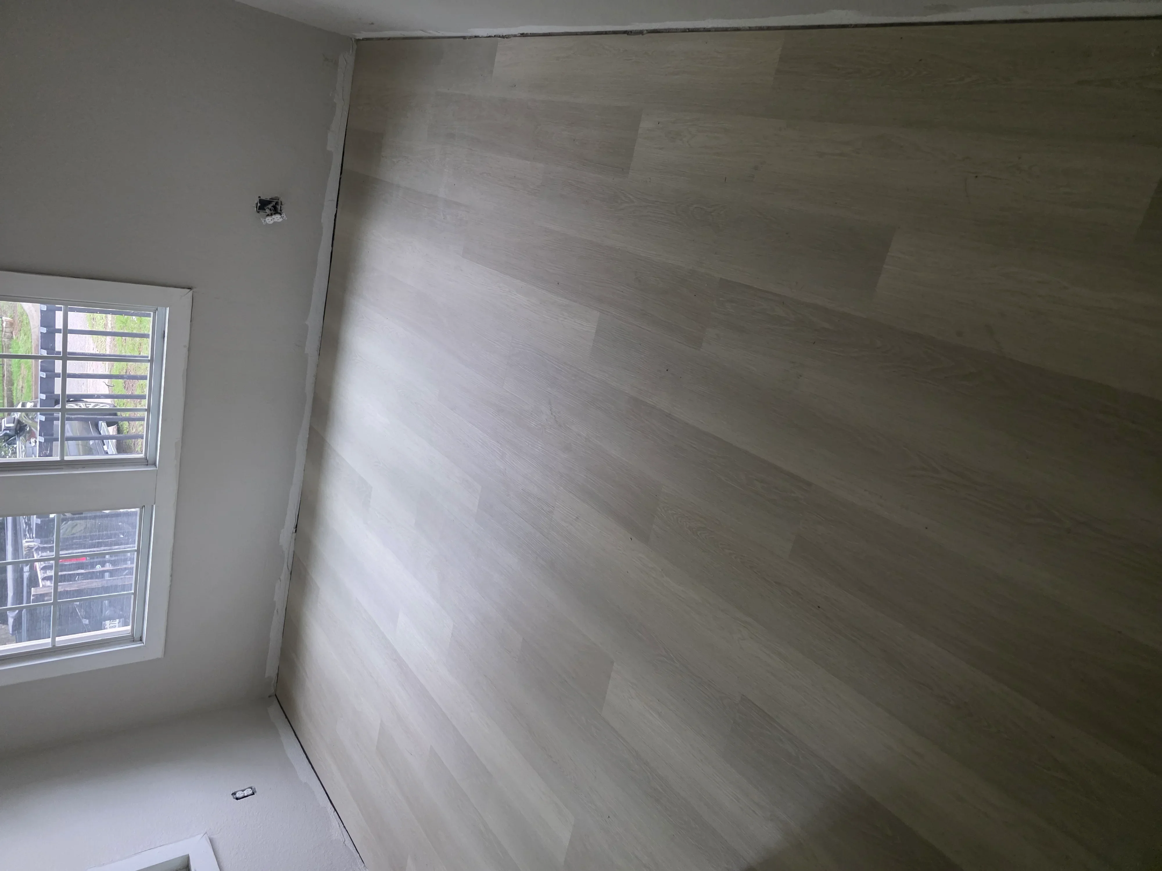 Drywall walls and ceiling with electrical outlet rough-in and window installation