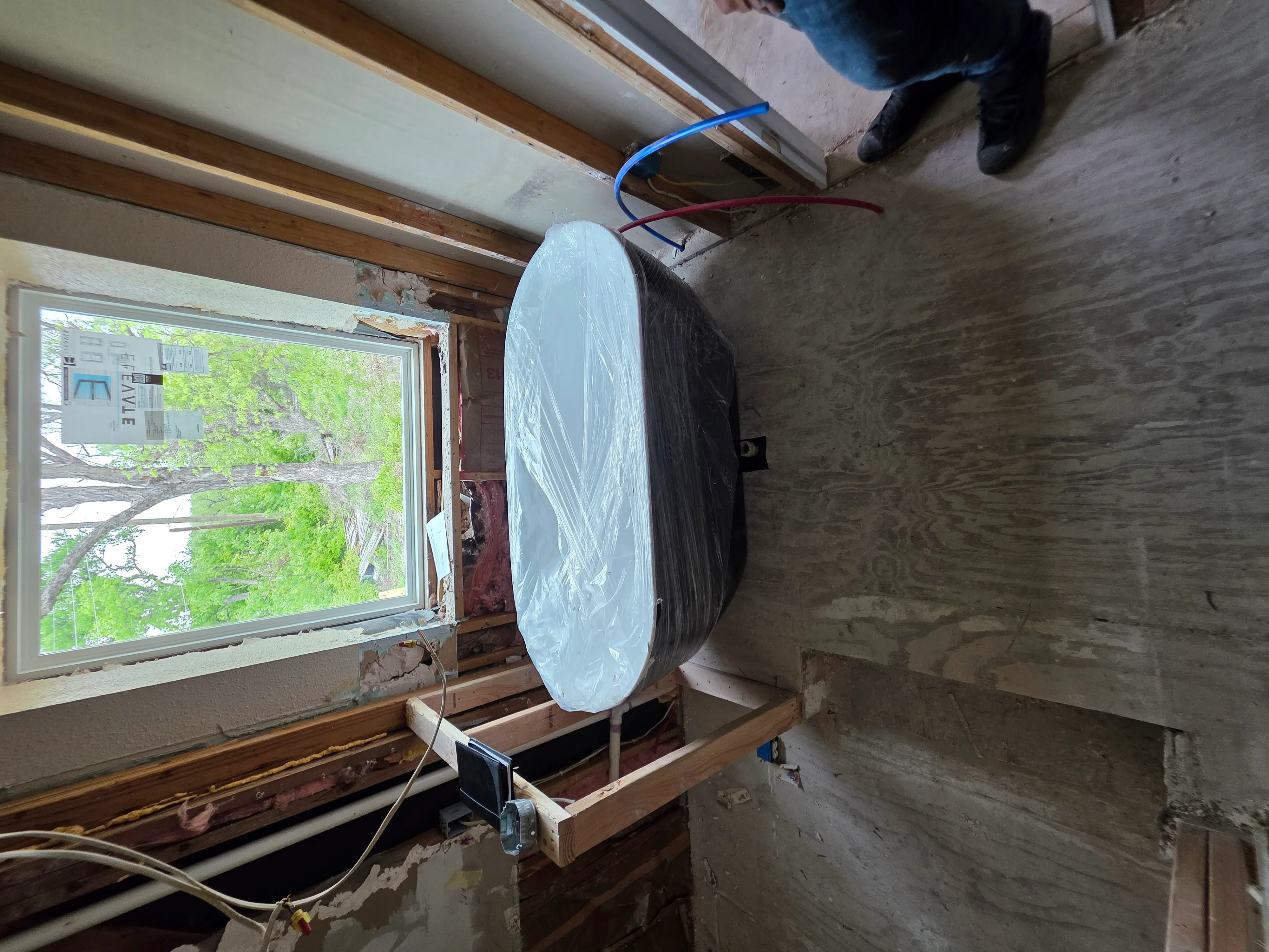 Basement electrical rough-in with Romex wiring and recessed light fixture installation