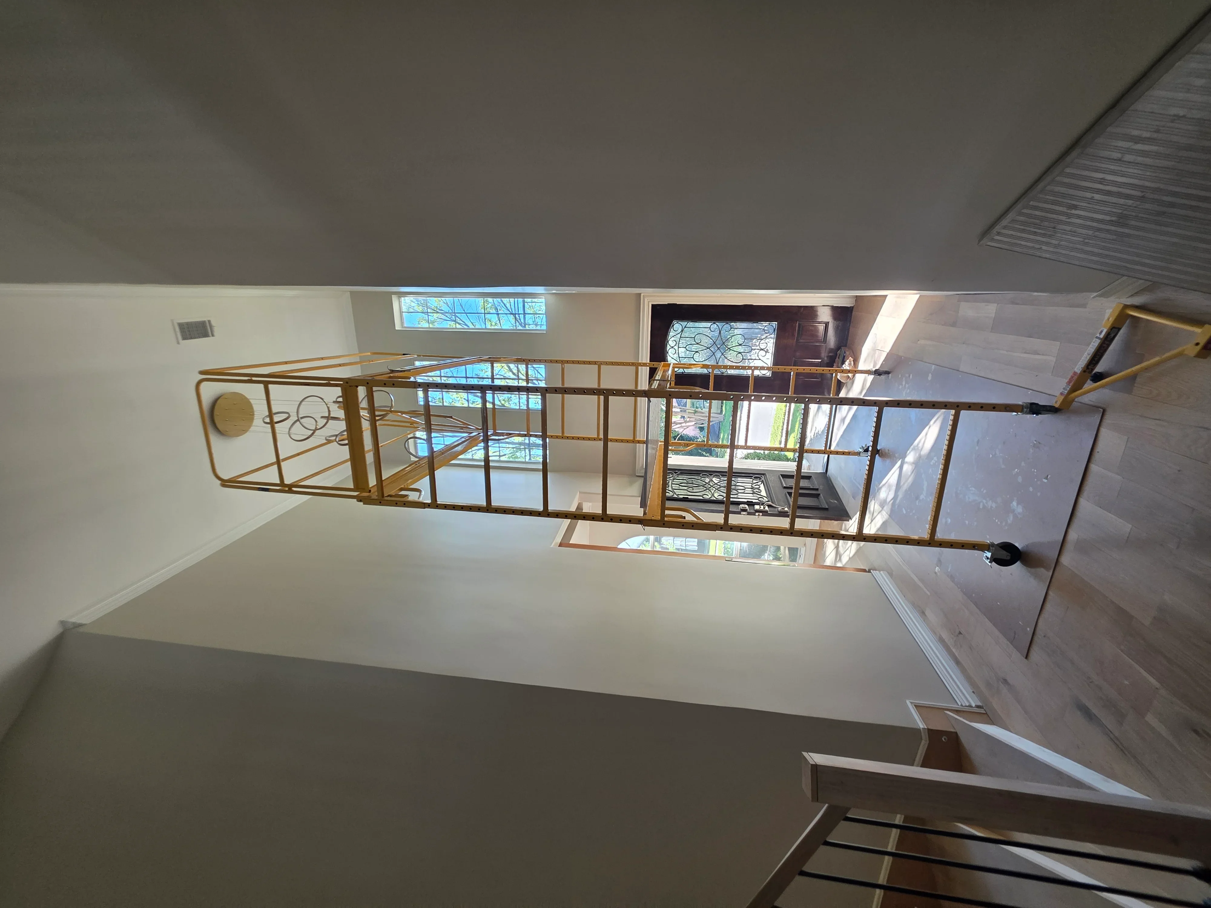 Loft mezzanine with recessed ceiling lights, glass railings, and electrical fixtures